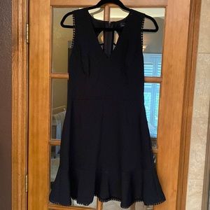 Black dress with flare detail and cut out back